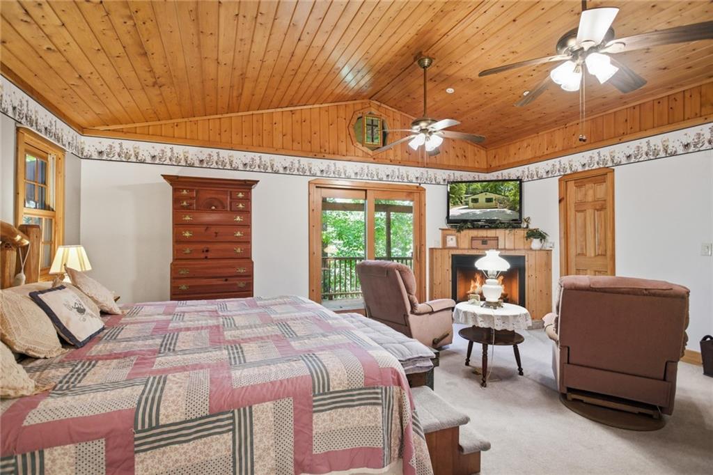 46 Spartan Lane Rabun Gap, GA 30568 - Photo 24 of 89 a bedroom with a bed and a chandelier