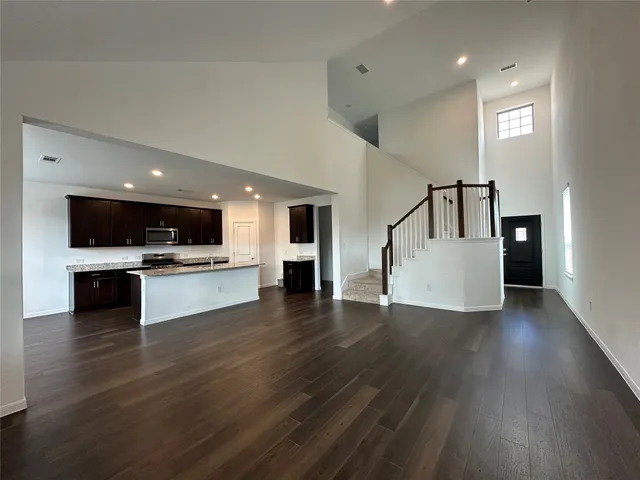 a view of kitchen with microwave and refrigerator