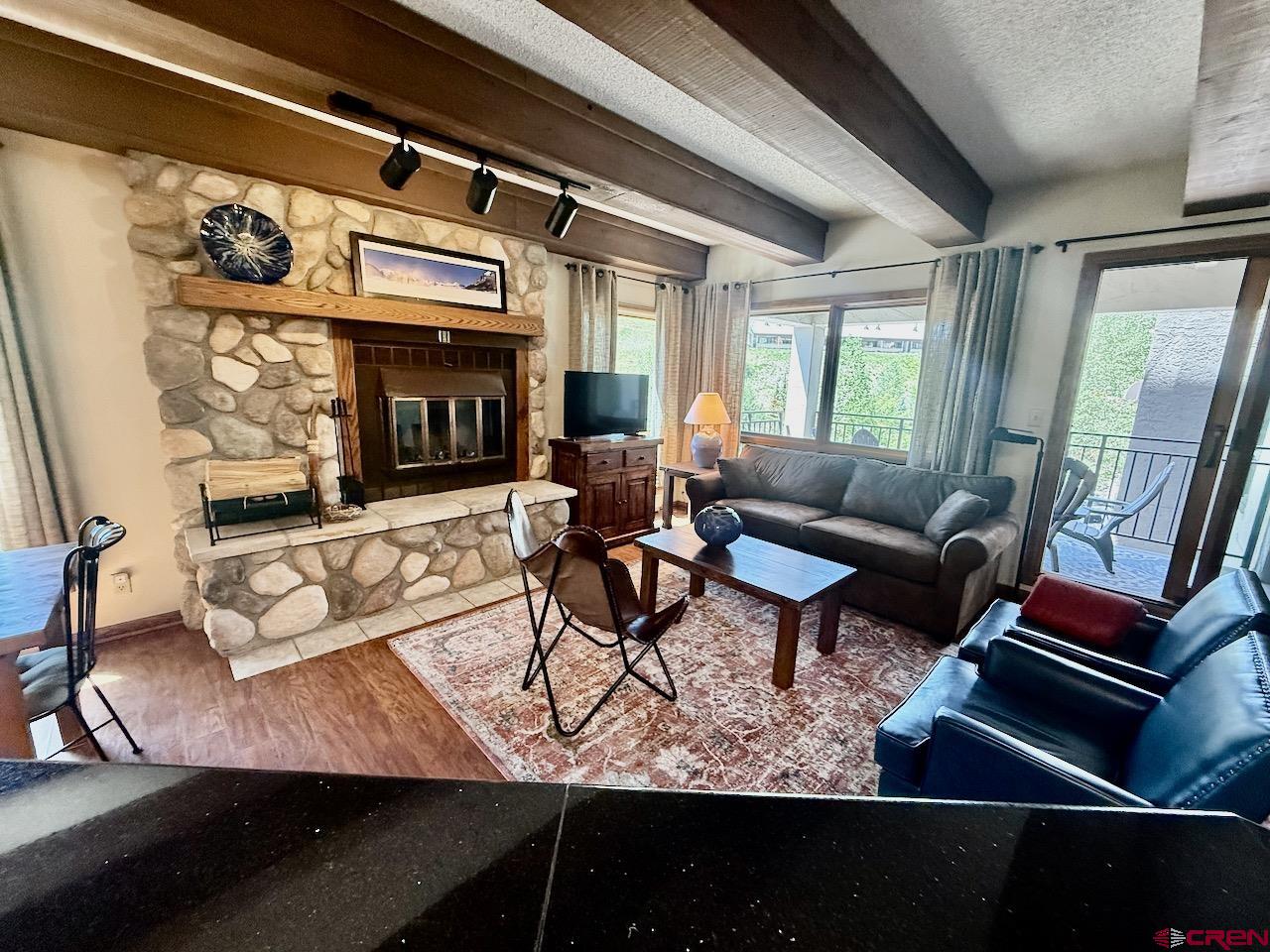 11 Snowmass Road, Unit 337 Crested Butte, CO 81225 - Photo 12 of 35 a living room with furniture fireplace and a large window
