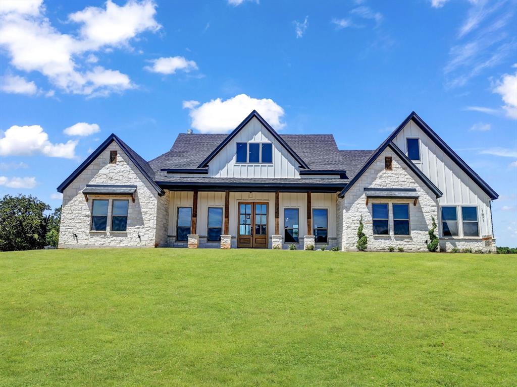 101 Dubois Road Poolville, TX 76487 - Photo 1 of 1 a view of a house with a big yard and large trees