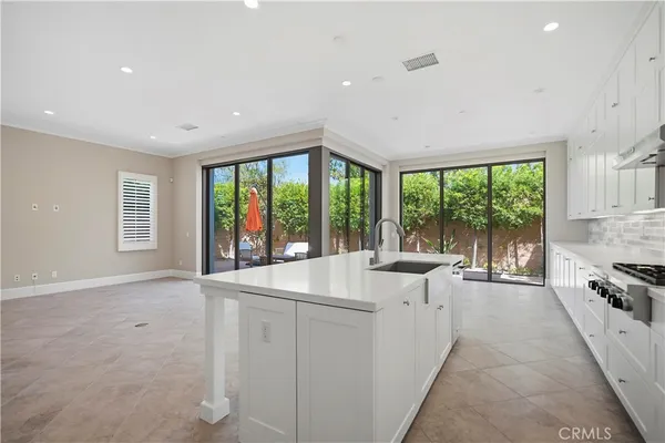 a large white kitchen with a large window