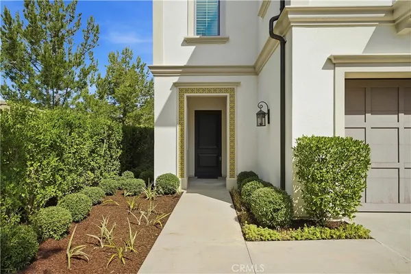 front view of a house with potted plants