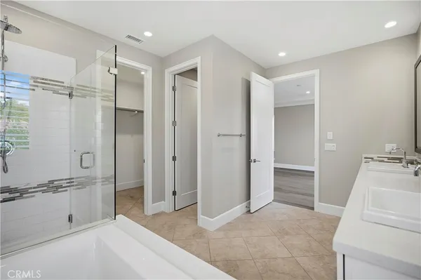 a spacious bathroom with a granite countertop tub sink and shower
