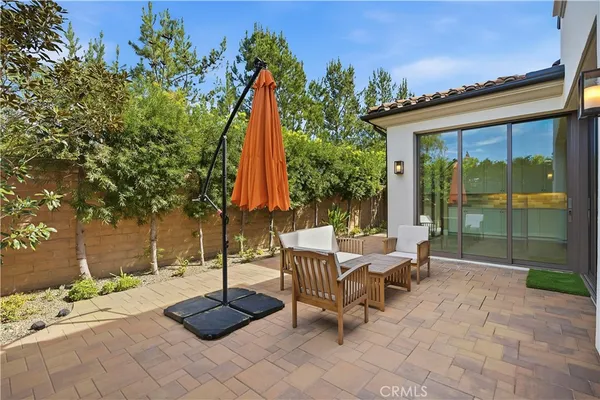 a view of backyard with a table and chairs