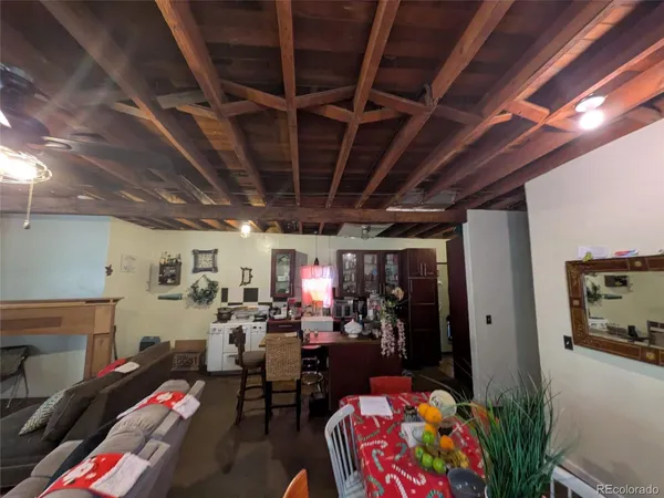 a living room with lots of furniture and clutter