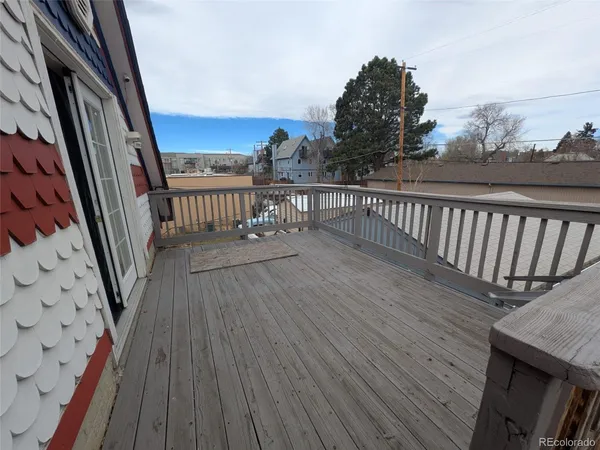 a view of a balcony with wooden floor