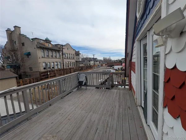 a view of a porch with a table and chairs