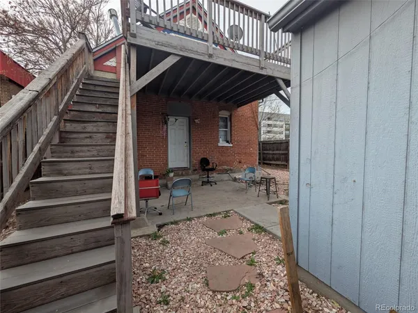 a backyard of a house with outdoor seating