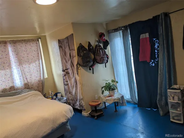 a bedroom with bed and a window