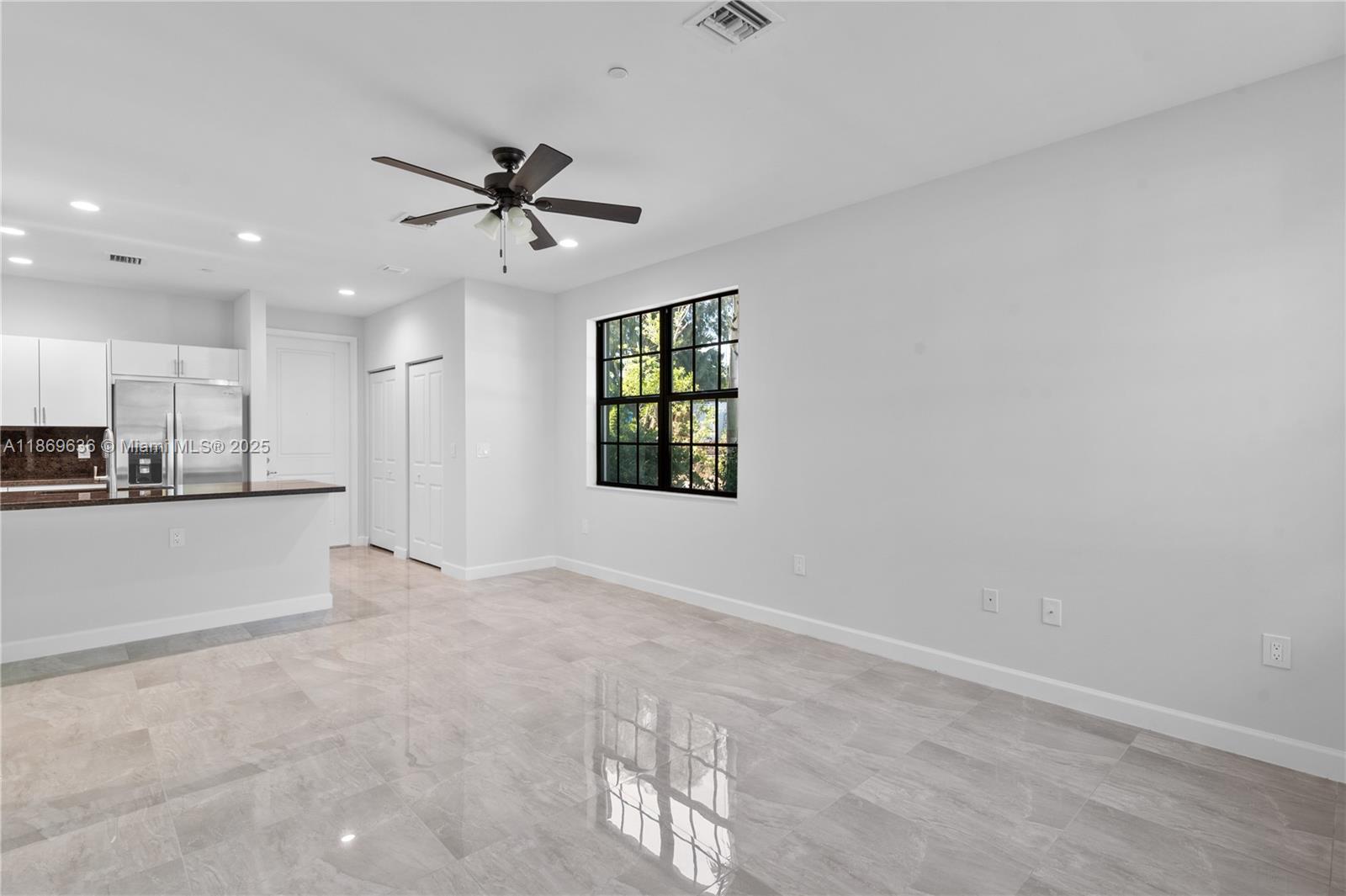 5750 Southwest 44th Street, Unit 201 Davie, FL 33314 - Photo 13 of 26 an empty room with windows and ceiling fan view