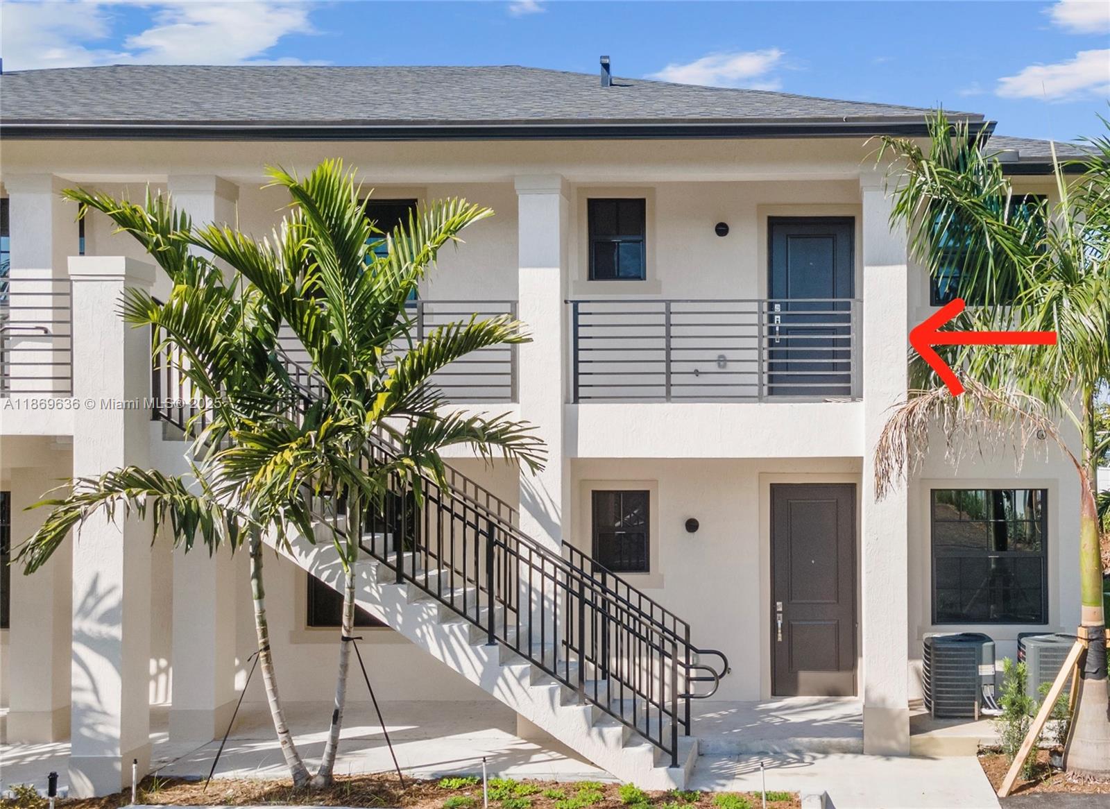 5750 Southwest 44th Street, Unit 201 Davie, FL 33314 - Photo 3 of 26 a front view of a house with a garage