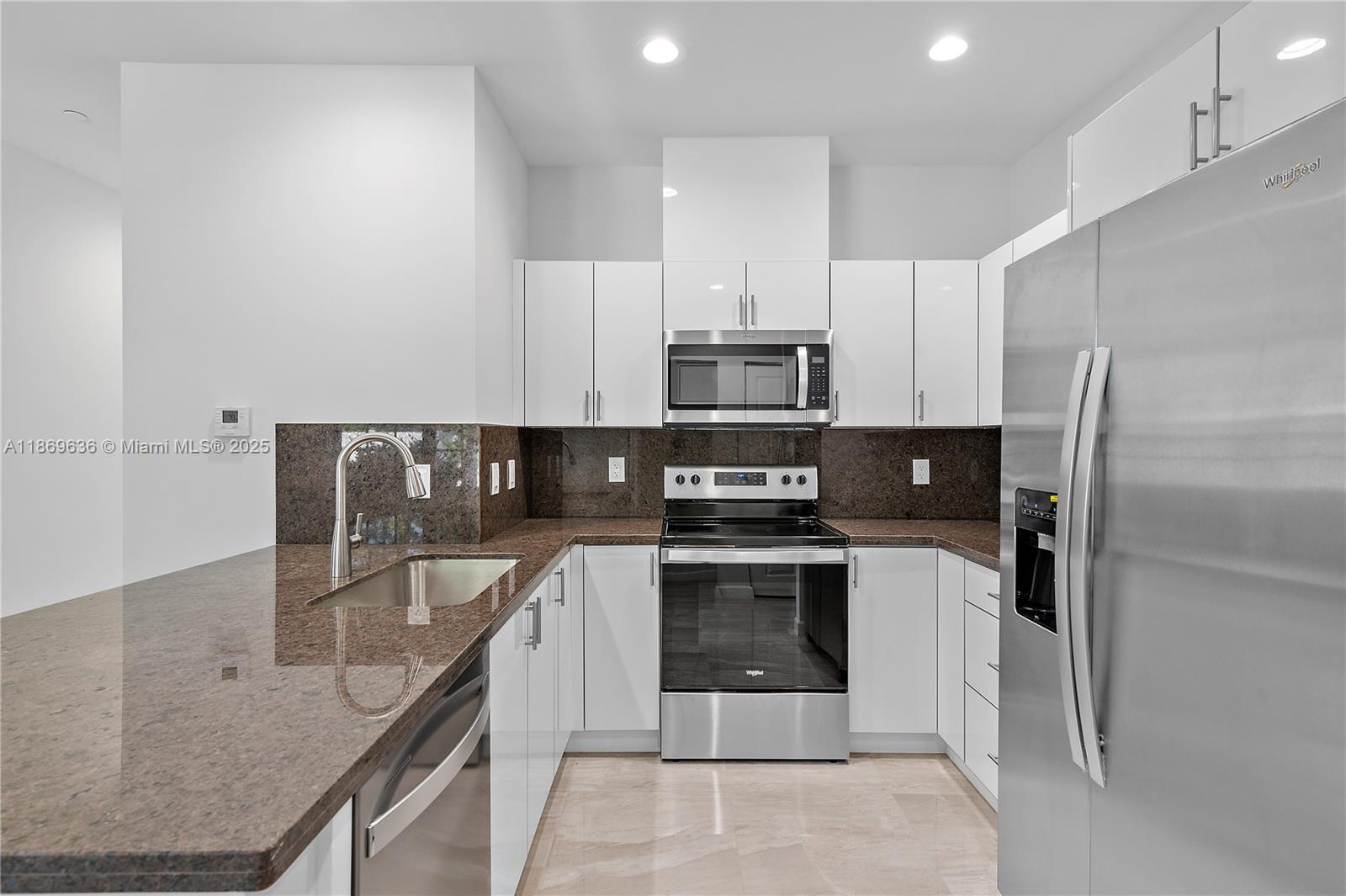 5750 Southwest 44th Street, Unit 201 Davie, FL 33314 - Photo 9 of 26 a kitchen with stainless steel appliances granite countertop a sink a stove a refrigerator and cabinets