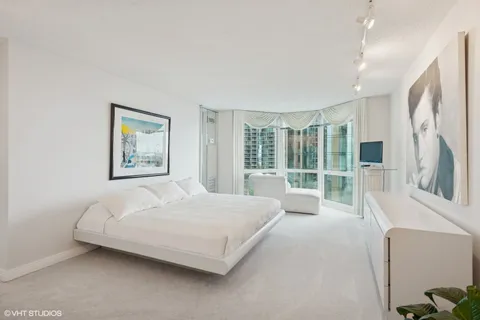 a bedroom with a large bed and a large window
