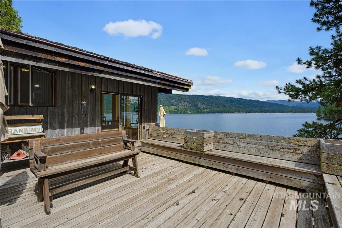 3800 Warren Wagon Road McCall, ID 83638 - Photo 30 of 50 Spacious outdoor deck with wide plank wood flooring and built-in benches, offering expansive lake scenery and distant mountain ranges