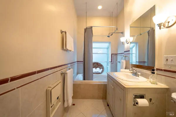 a bathroom with a sink mirror and shower