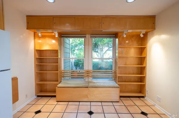a room with a wooden floor and a large window