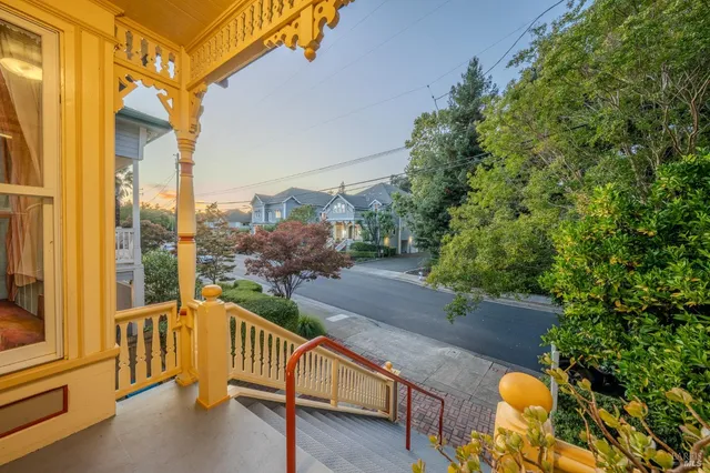 a view of a brick house with a large windows and a small yard