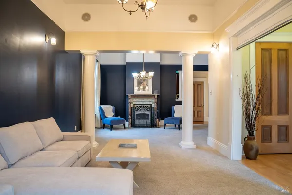 a living room with furniture and a chandelier