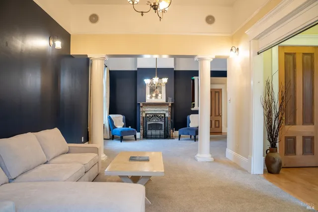 a living room with furniture and a chandelier