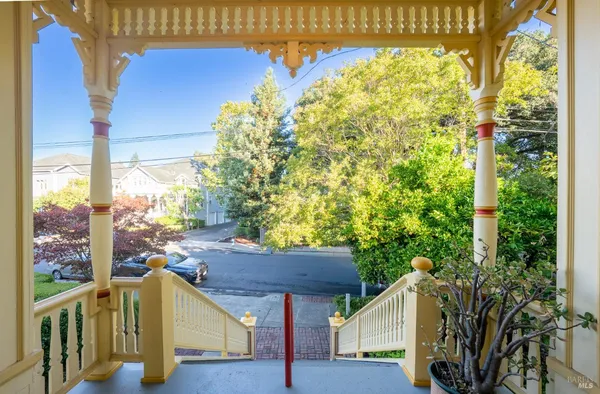 a view of balcony with furniture and garden