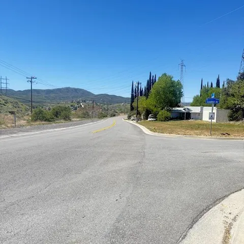 a view of a road with a building in the background
