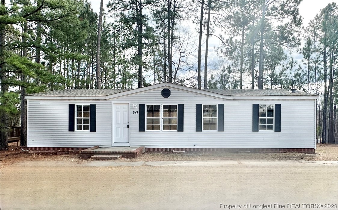 50 Wood Croft Sanford, NC 27332 - Photo 1 of 19 a front view of a house with a yard and garage