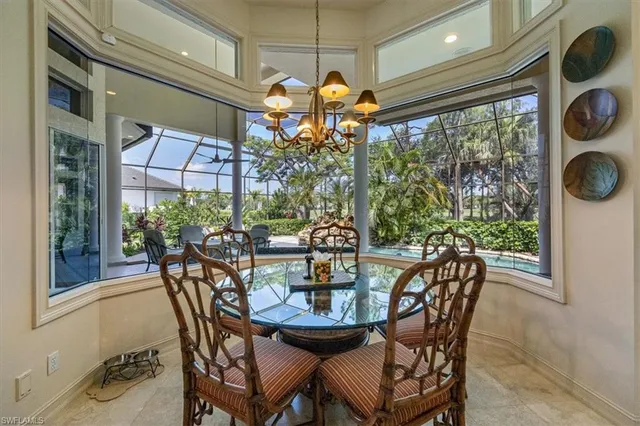 a view of a dining room with furniture and chandelier