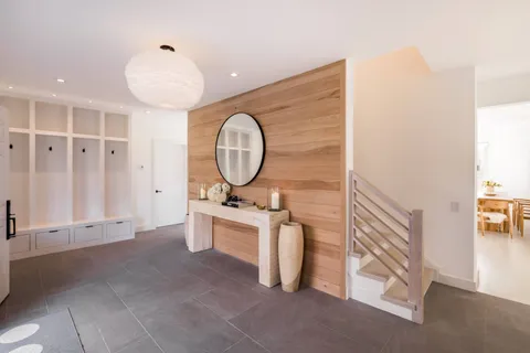 a view of a livingroom with wooden floor and furniture