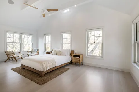 a spacious bedroom with a bed and window