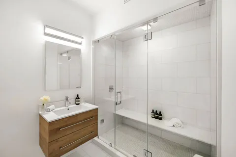 a bathroom with a bathtub sink and shower