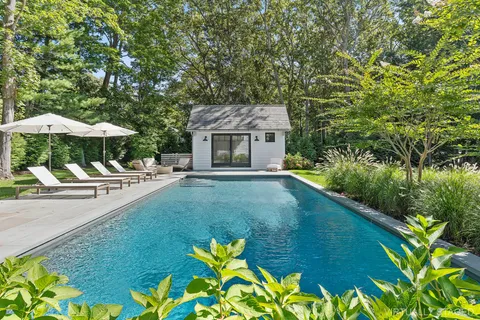 a view of a house with backyard and sitting area