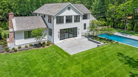 a front view of a house with a yard and porch