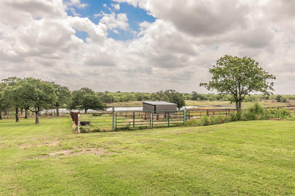 495 Lyles Road Henrietta, TX 76365 - Photo 18 of 18 View of yard featuring an outdoor structure and a rural view