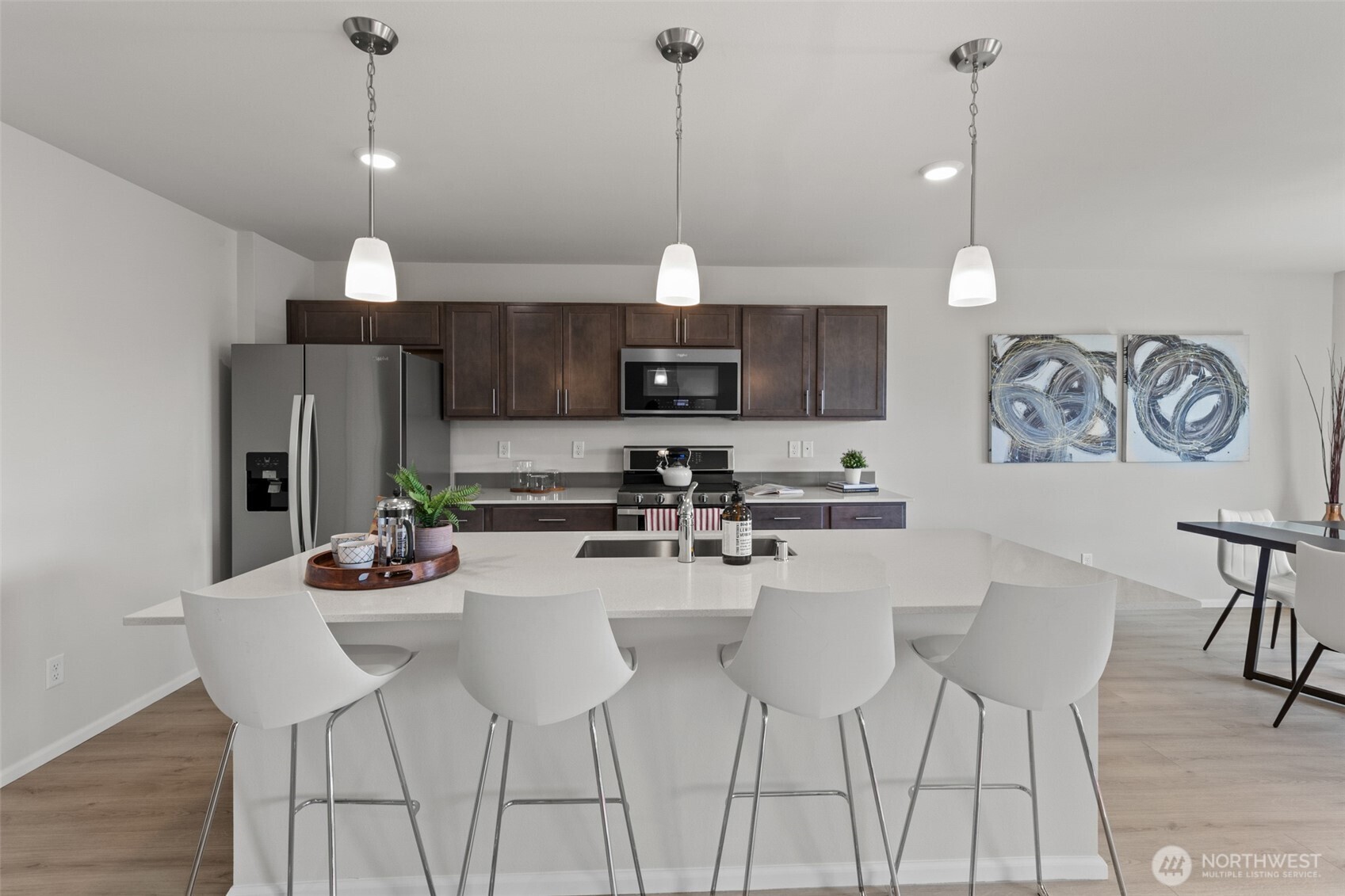 32302 135th Place Southeast Sultan, WA 98294 - Photo 12 of 32 a kitchen with stainless steel appliances granite countertop a dining table chairs and white cabinets