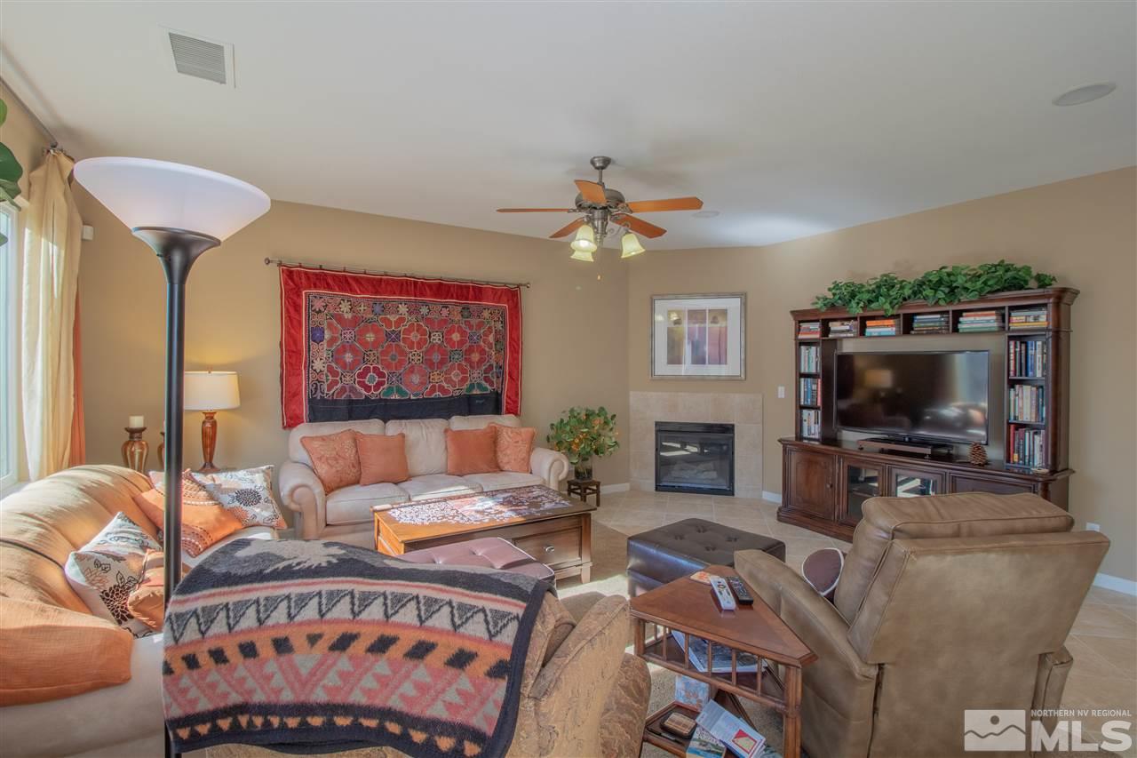 2000 Angel Ridge Drive Reno, NV 89521 - Photo 8 of 18 a living room with furniture a flat screen tv and a fireplace