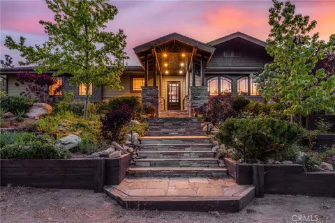 a dining room with furniture a floor to ceiling window and wooden floor