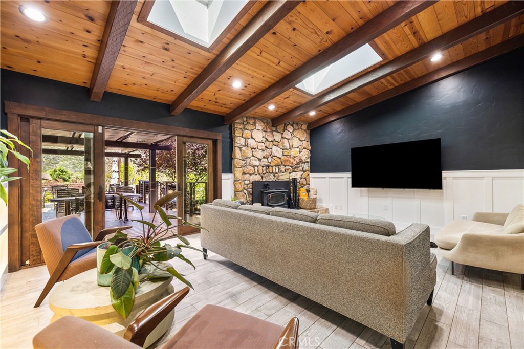 59353 Hop Patch Spring Road Mountain Center, CA 92561 - Photo 11 of 68 a living room with furniture a flat screen tv and a chandelier