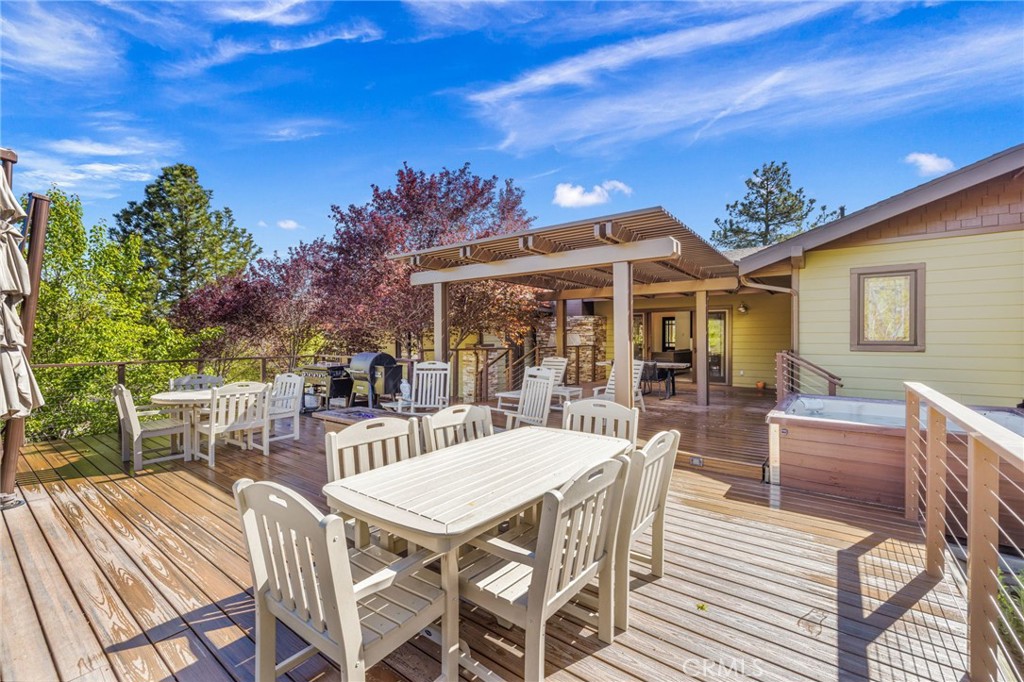 59353 Hop Patch Spring Road Mountain Center, CA 92561 - Photo 39 of 68 a view of a patio with table and chairs with wooden floor and fence