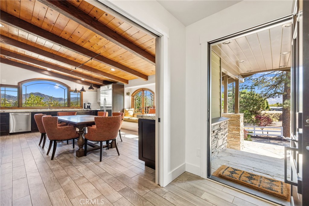 59353 Hop Patch Spring Road Mountain Center, CA 92561 - Photo 5 of 68 a dining room with furniture a floor to ceiling window and wooden floor