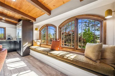 a view of a patio with table and chairs with wooden floor and fence