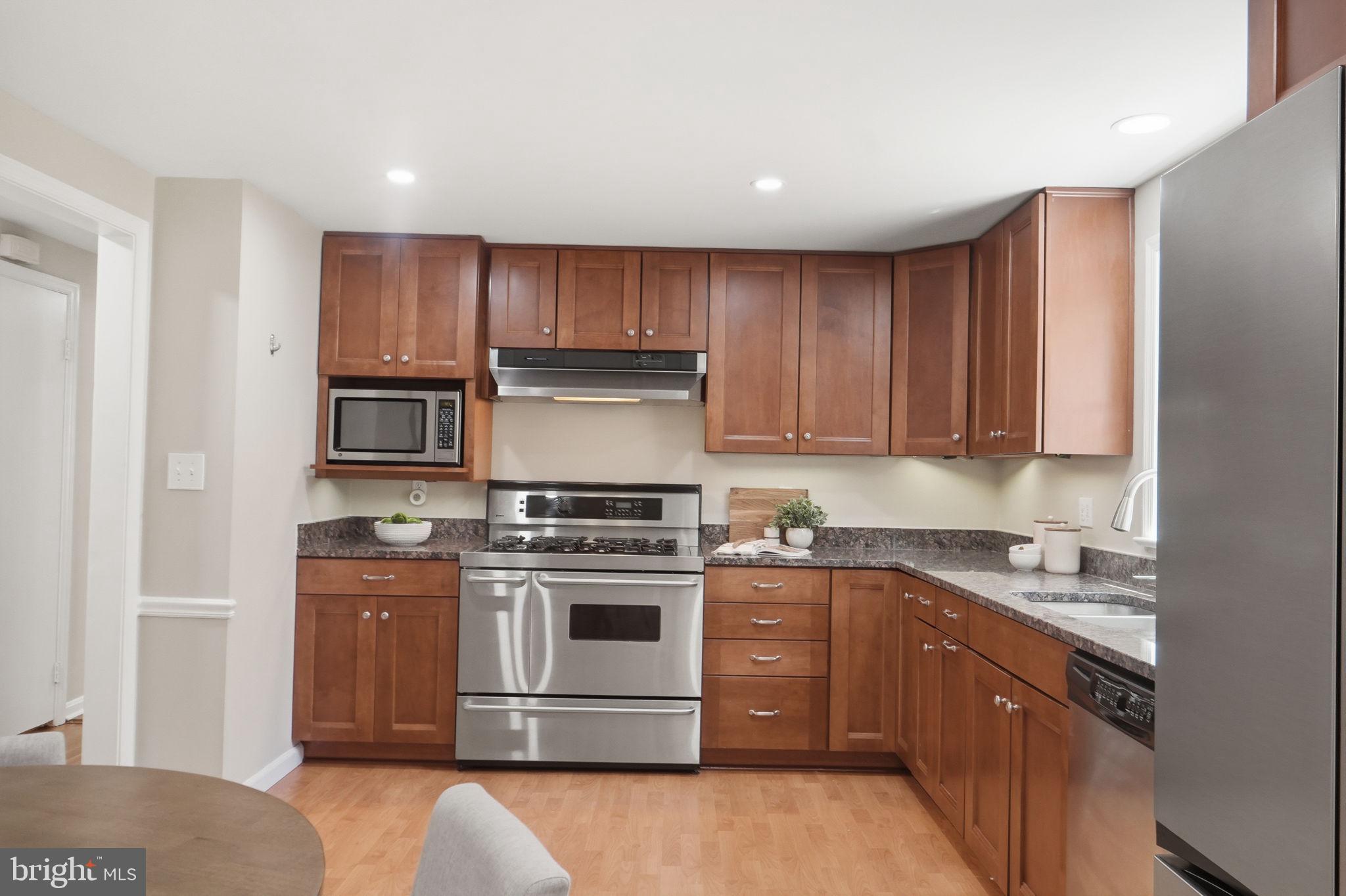 8008 Inspection House Road Potomac, MD 20854 - Photo 8 of 43 Modern kitchen with warm wood tones.