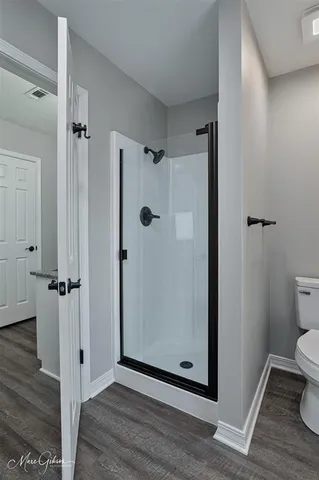 a view of a bathroom with wooden floor