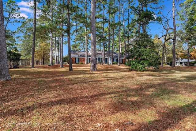 a front view of a building with trees