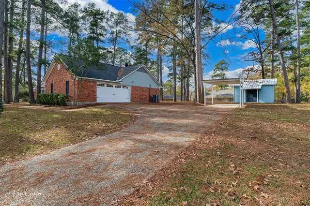 a view of a house with a tree in front
