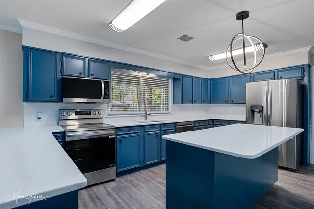 a kitchen with sink a stove and refrigerator