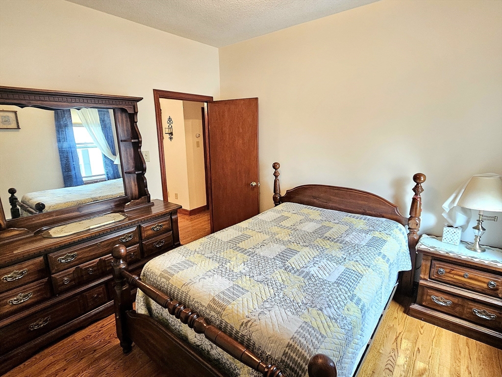 460 William Street Fall River, MA 02721 - Photo 13 of 23 a bedroom with a bed and wooden floor