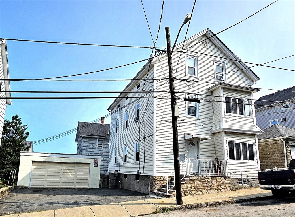 460 William Street Fall River, MA 02721 - Photo 2 of 23 a front view of a house with garage