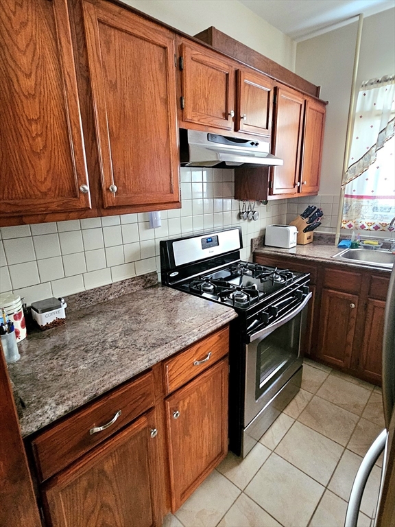 460 William Street Fall River, MA 02721 - Photo 5 of 23 a kitchen with stainless steel appliances granite countertop a sink stove and cabinets