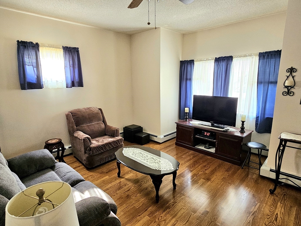 460 William Street Fall River, MA 02721 - Photo 8 of 23 a living room with furniture and a flat screen tv