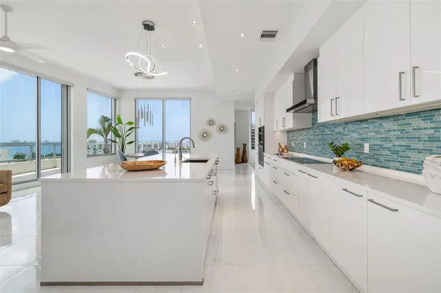 a large kitchen with stainless steel appliances granite countertop a lot of counter space and wooden floor